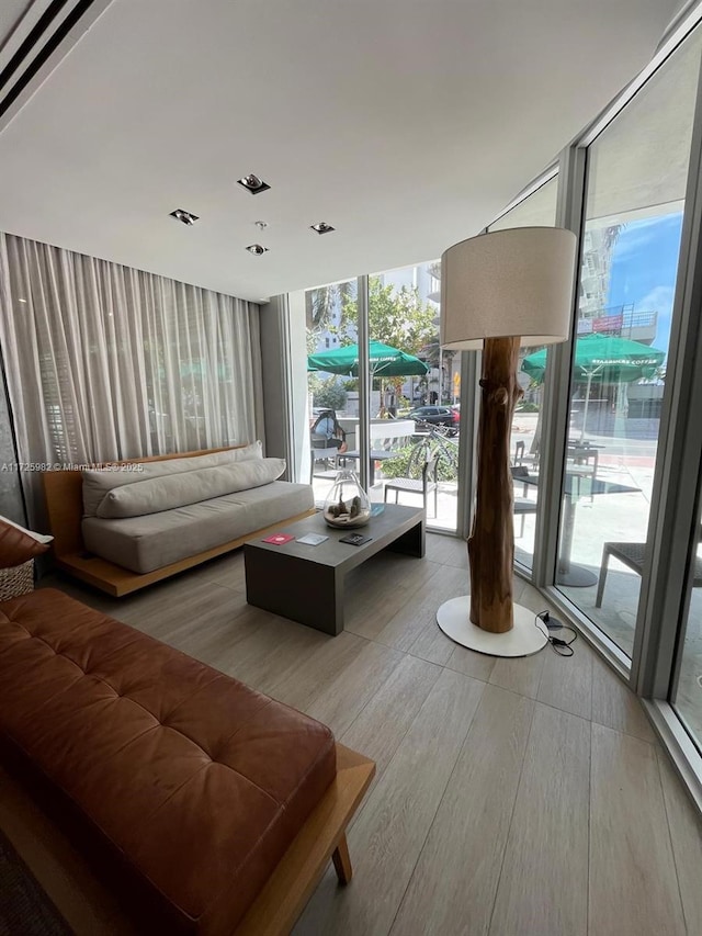 living room with plenty of natural light and expansive windows