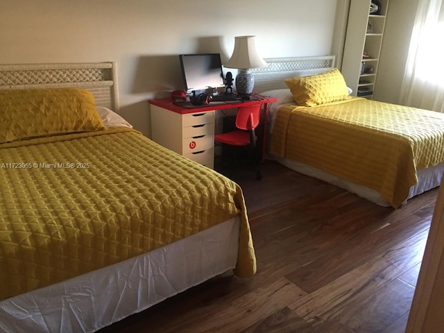 bedroom with dark wood-type flooring