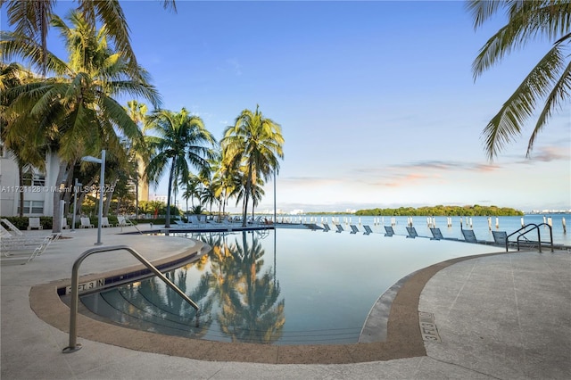 pool at dusk with a water view