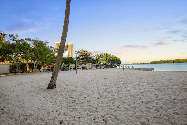 view of home's community featuring volleyball court and a water view