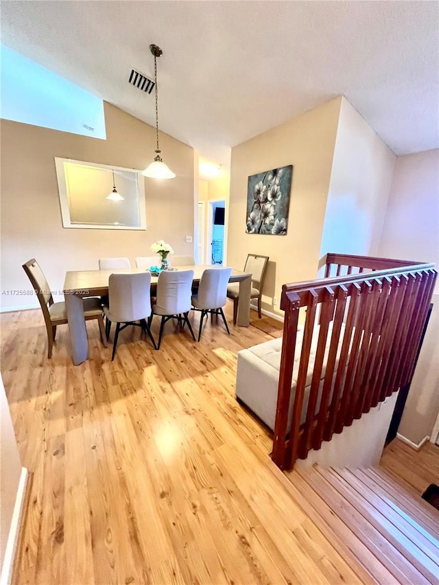10 Via De Casas Sur Unit 205, Boynton Beach, FL 33426 - dining room with light wood-style flooring, vaulted ceiling, and visible vents