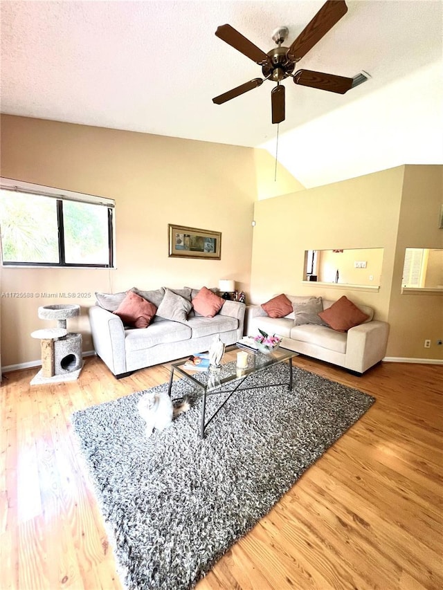 10 Via De Casas Sur Unit 205, Boynton Beach, FL 33426 - living area with a textured ceiling, wood finished floors, a ceiling fan, and vaulted ceiling