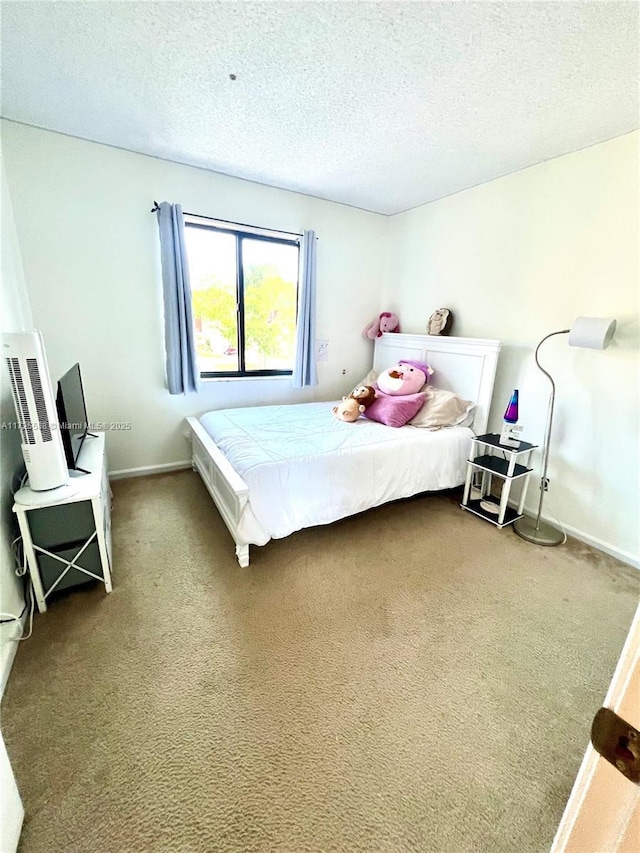 bedroom featuring a textured ceiling and carpet flooring