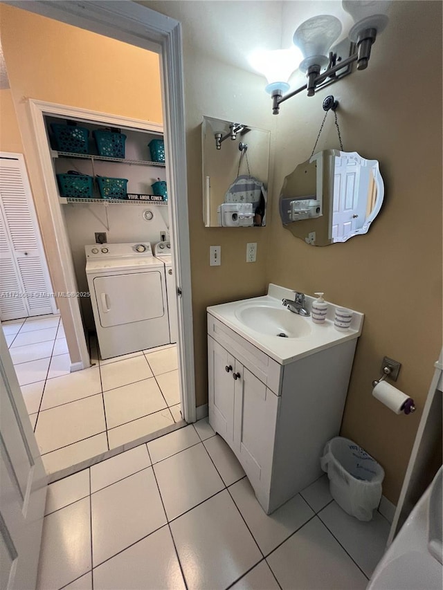 bathroom with vanity, tile patterned floors, and separate washer and dryer