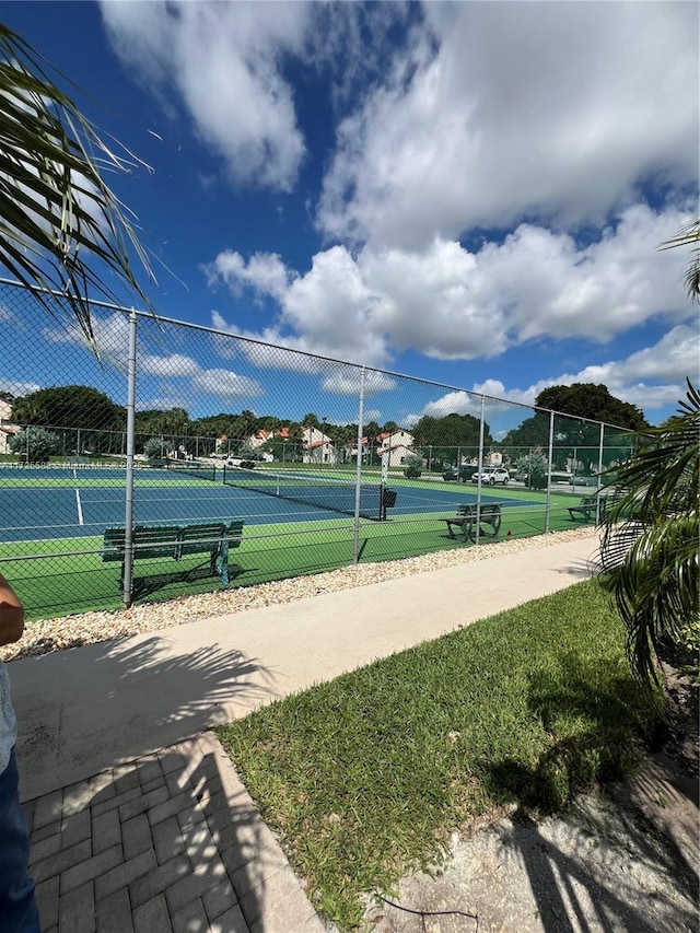 view of property's community featuring tennis court