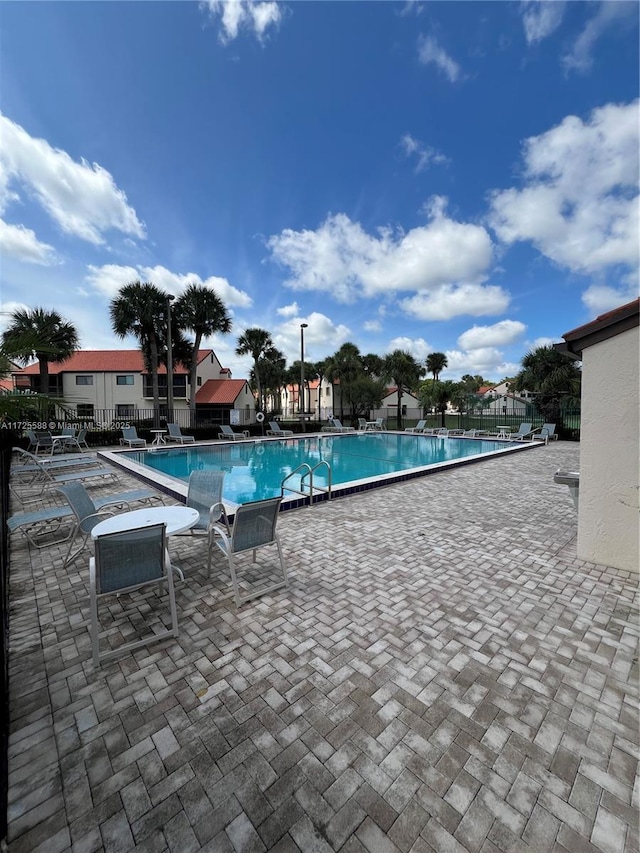 10 Via De Casas Sur Unit 205, Boynton Beach, FL 33426 - community pool featuring a patio area and fence