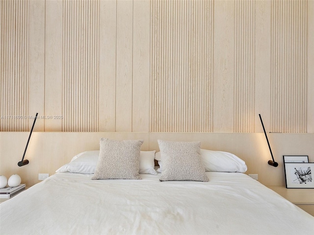 bedroom featuring wood walls