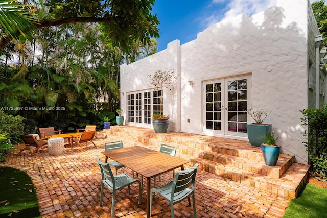 view of patio featuring french doors and a fire pit