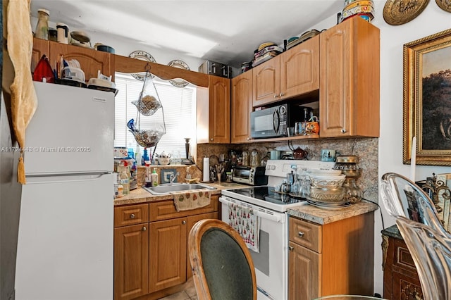 kitchen featuring sink, white appliances, and tasteful backsplash