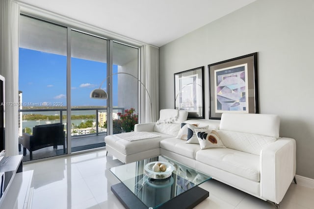 tiled living room featuring a wall of windows