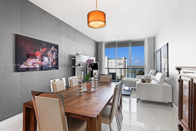 tiled dining room featuring expansive windows