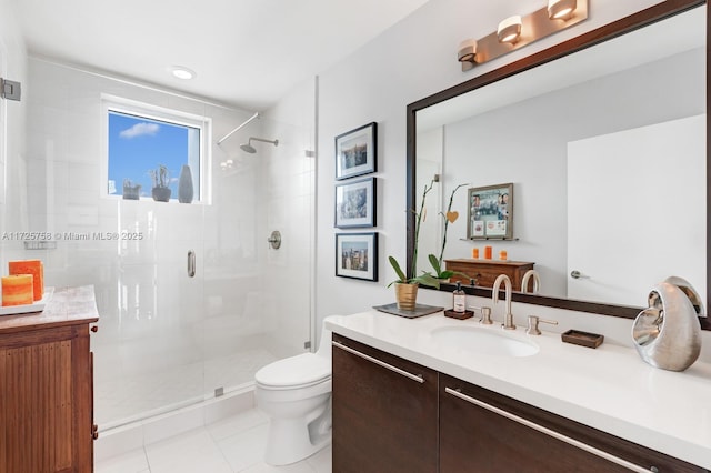 bathroom featuring toilet, an enclosed shower, tile patterned floors, and vanity