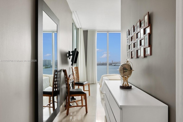 interior space with a healthy amount of sunlight, light tile patterned flooring, and expansive windows