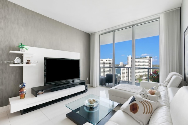 tiled living room featuring a wall of windows