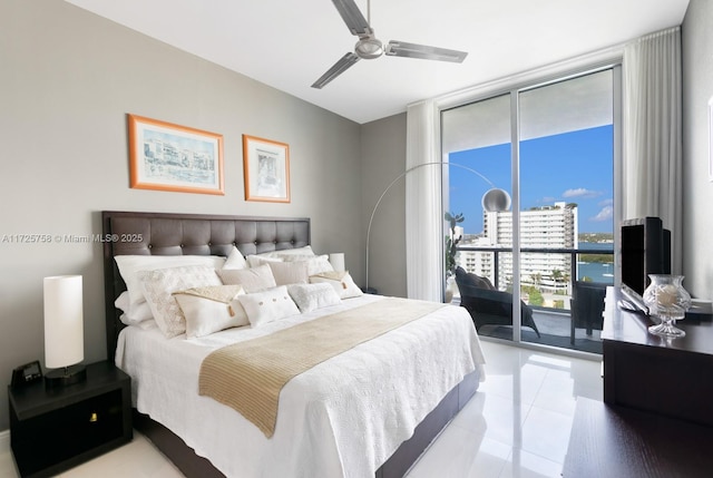 tiled bedroom featuring ceiling fan, access to exterior, and a wall of windows