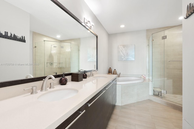 bathroom featuring separate shower and tub and vanity