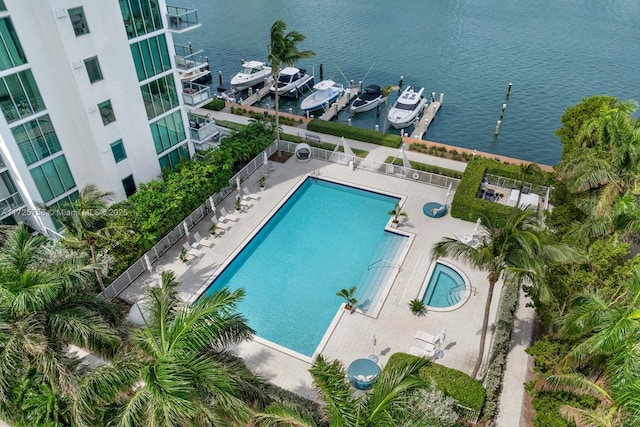 view of pool with a patio area and a water view