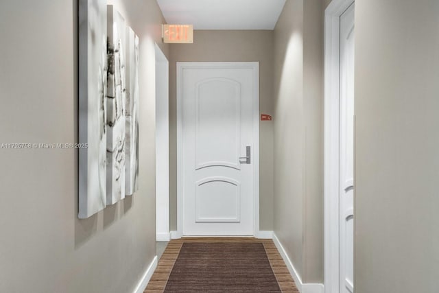 hallway with hardwood / wood-style floors