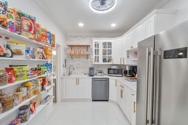 kitchen with sink, crown molding, stainless steel appliances, and white cabinets