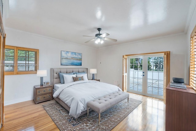bedroom with multiple windows, access to exterior, ornamental molding, and light hardwood / wood-style floors