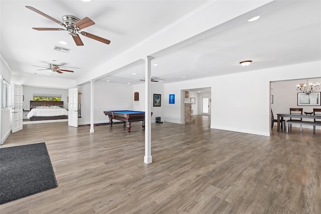 rec room with hardwood / wood-style floors, ceiling fan with notable chandelier, and billiards