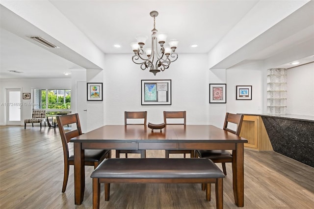 dining area featuring an inviting chandelier and light wood-type flooring