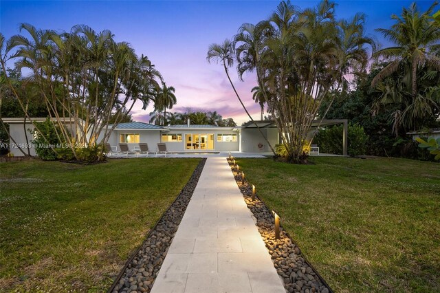 ranch-style house featuring a yard