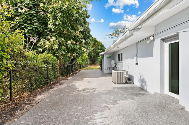 view of home's exterior with a patio and central air condition unit