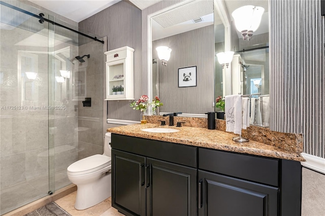 bathroom featuring toilet, vanity, tile patterned floors, and walk in shower