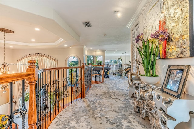 hallway with carpet floors and crown molding