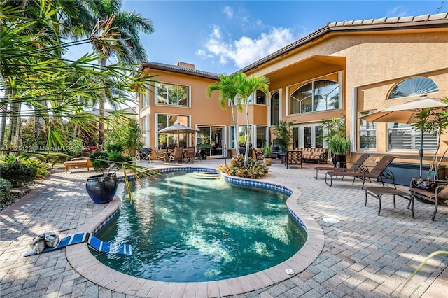 view of swimming pool with outdoor lounge area and a patio