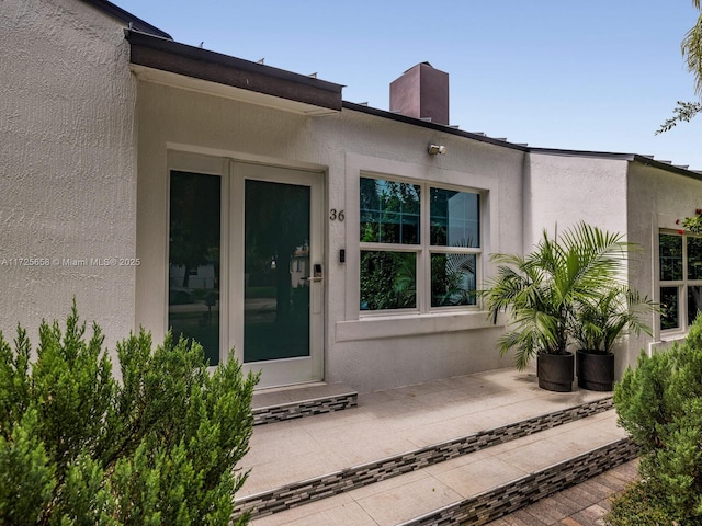 entrance to property featuring a patio area