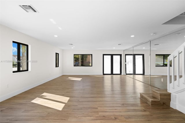 unfurnished room featuring light wood-type flooring and french doors