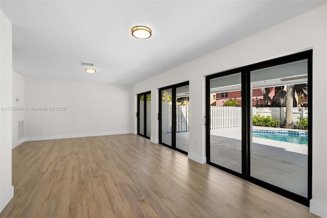 spare room featuring light wood-type flooring