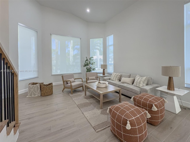 living area with recessed lighting, baseboards, and wood finished floors