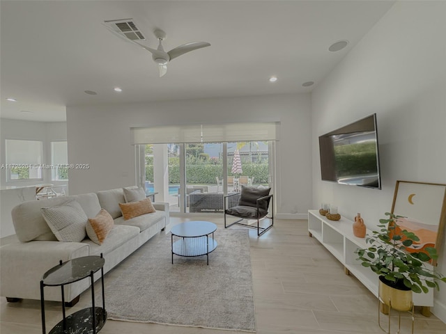 living area with baseboards, a ceiling fan, visible vents, and recessed lighting