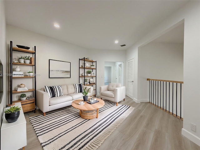 living room with light wood-style floors, recessed lighting, visible vents, and baseboards