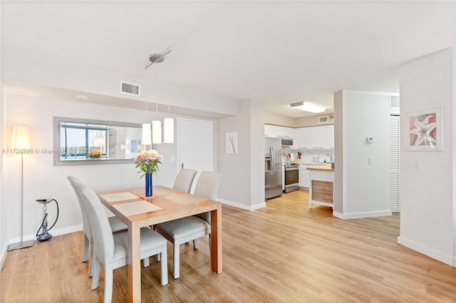 dining area with light hardwood / wood-style floors