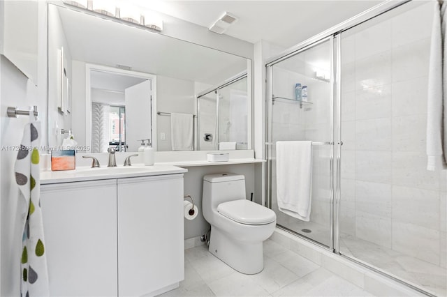 bathroom featuring toilet, a shower with door, tile patterned floors, and vanity