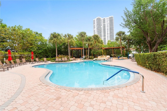 view of pool featuring a pergola and a patio area