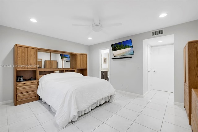 tiled bedroom featuring ensuite bathroom and ceiling fan