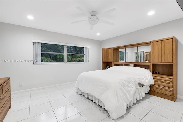 bedroom with ceiling fan, light tile patterned flooring, and multiple windows