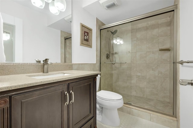 bathroom with toilet, tile patterned flooring, walk in shower, and vanity