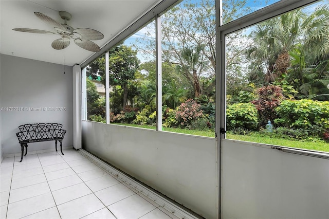 unfurnished sunroom with ceiling fan