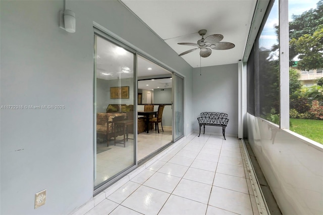 unfurnished sunroom featuring ceiling fan