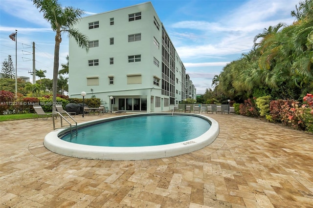 view of swimming pool with a patio