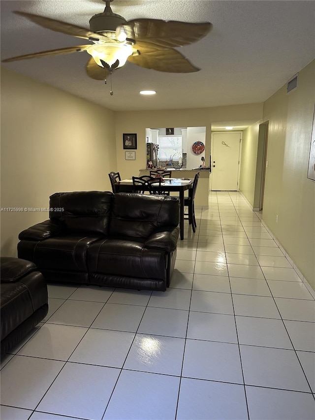 living room featuring ceiling fan and light tile patterned floors