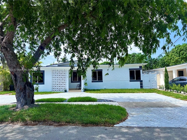 6181 SW 20th St, West Miami, FL 33155 - ranch-style house with decorative driveway and a front lawn