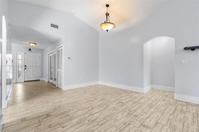 empty room featuring vaulted ceiling