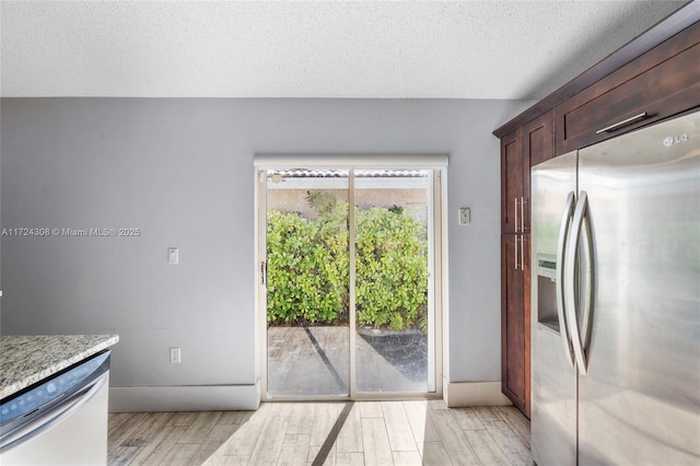 kitchen with a textured ceiling and stainless steel appliances